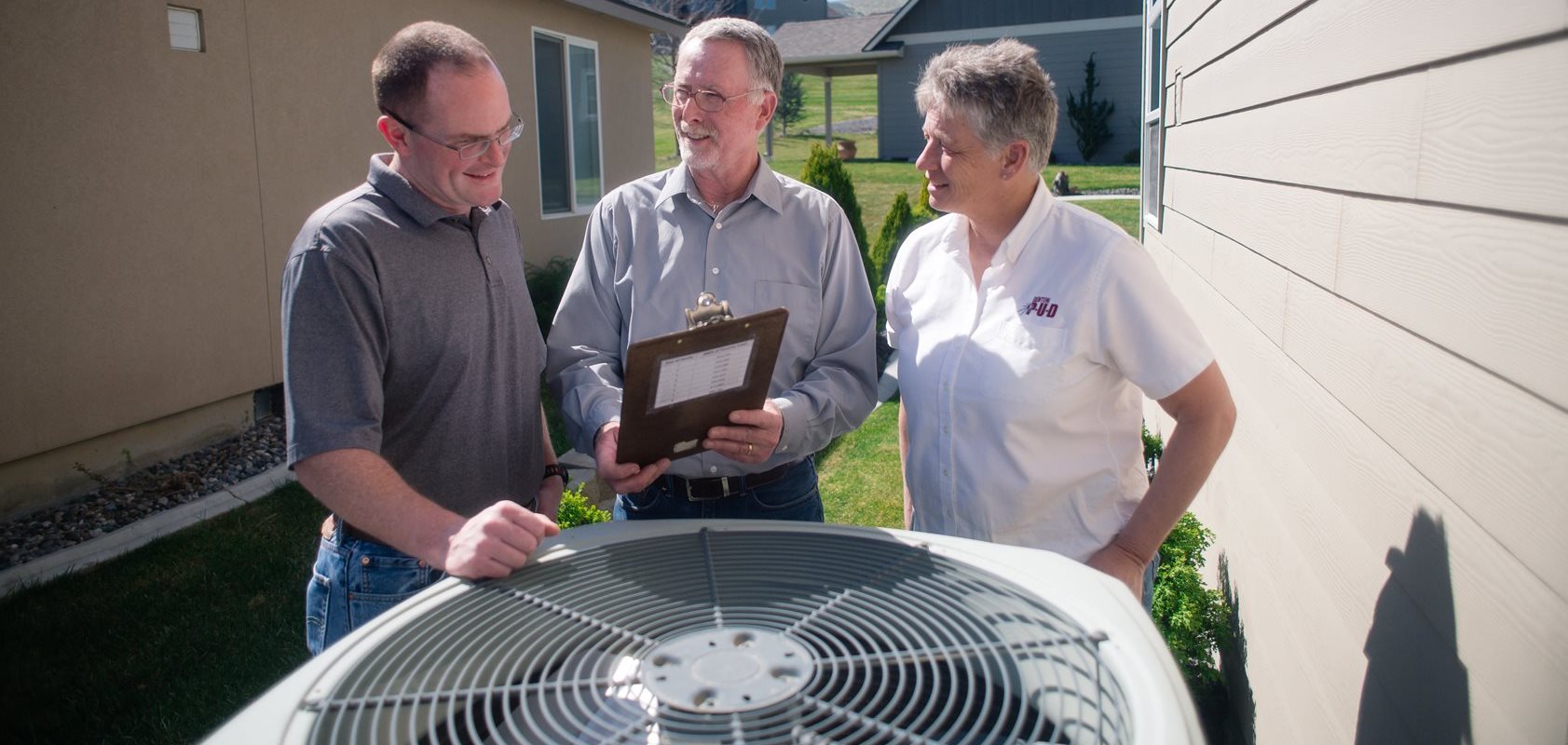 Energy efficiency advisors performing an at-home energy audit for a customer
